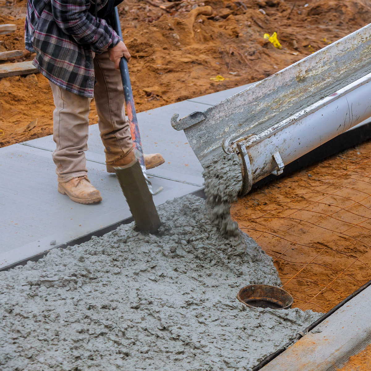 concrete delivered by tkm materials being poured at construction site