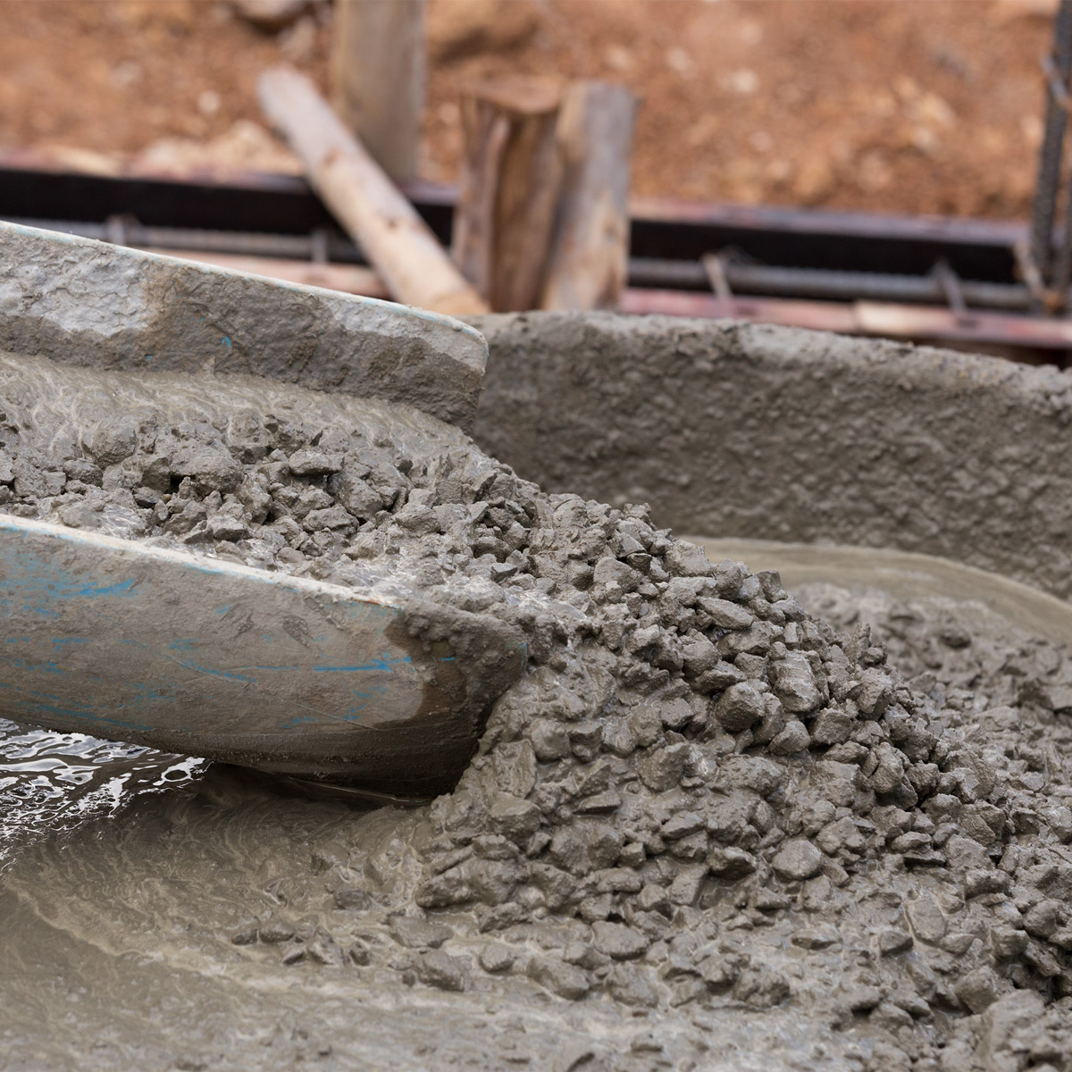 concrete being poured into wheel barrow from tkm materials